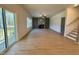 View of the living room featuring a fireplace, access to a deck, and an open staircase at 168 Grand Griffon Way, Lillington, NC 27546