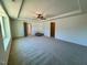 Spacious carpeted primary bedroom featuring a ceiling fan and tray ceiling at 168 Grand Griffon Way, Lillington, NC 27546