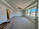 Large primary bedroom featuring a ceiling fan, tray ceiling, and carpet at 168 Grand Griffon Way, Lillington, NC 27546