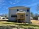 The backyard features a wooden deck, a well-manicured lawn, and a two-story home with gray siding at 168 Grand Griffon Way, Lillington, NC 27546