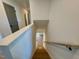 Wooden staircase leading to a lower level with hardwood floors at 168 Grand Griffon Way, Lillington, NC 27546