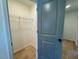 Open walk-in closet boasts wire shelving, hardwood floor and is bright from hall window at 168 Grand Griffon Way, Lillington, NC 27546