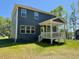 The house has a covered back porch and a large backyard at 196 Grand Griffon Way, Lillington, NC 27546