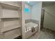 Bathroom features a soaking tub and a glass enclosed shower with gray tile at 196 Grand Griffon Way, Lillington, NC 27546