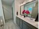 Bathroom features double vanity with framed mirror, plus grey cabinets and white countertops at 196 Grand Griffon Way, Lillington, NC 27546