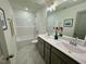Elegant bathroom featuring double sinks, a large mirror, and a shower-tub combination at 196 Grand Griffon Way, Lillington, NC 27546