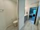 Bright bathroom featuring a toilet, vanity, and view into the carpeted bedroom at 196 Grand Griffon Way, Lillington, NC 27546