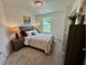 Bedroom has large window, decor in neutral tones, and a modern ceiling light at 196 Grand Griffon Way, Lillington, NC 27546