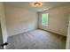 Bedroom featuring carpet flooring, white walls, a window and a ceiling light at 196 Grand Griffon Way, Lillington, NC 27546