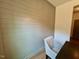 Cozy dining area with stylish wall paneling, wood floors and adjacent workstation at 196 Grand Griffon Way, Lillington, NC 27546