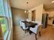 Dining room with wood floors, stylish chandelier and large windows bringing in natural light at 196 Grand Griffon Way, Lillington, NC 27546