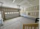 Spacious two-car garage with concrete flooring and a window-equipped garage door at 196 Grand Griffon Way, Lillington, NC 27546