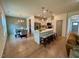 Open-concept kitchen with stainless steel appliances, a spacious island, and a dining area bathed in natural light at 196 Grand Griffon Way, Lillington, NC 27546