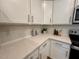 Bright kitchen featuring shaker cabinets, quartz countertops, and stylish backsplash at 196 Grand Griffon Way, Lillington, NC 27546
