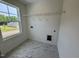 Bright laundry room featuring stylish tile floors, window, and wire shelving at 196 Grand Griffon Way, Lillington, NC 27546