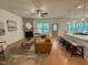 Open-concept living room with a modern fireplace, sleek bar seating, and abundant natural light at 196 Grand Griffon Way, Lillington, NC 27546