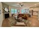 Bright and open living room featuring a fireplace, hardwood floors, and seamless flow to the kitchen at 196 Grand Griffon Way, Lillington, NC 27546