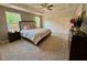Spacious main bedroom featuring tray ceiling, carpet floors, and two large windows at 196 Grand Griffon Way, Lillington, NC 27546