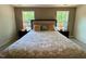 Well-lit main bedroom with carpet, a decorative tray ceiling, and large windows at 196 Grand Griffon Way, Lillington, NC 27546
