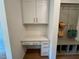 Mudroom features built-in desk, overhead cabinets, and cubbies for organization at 196 Grand Griffon Way, Lillington, NC 27546