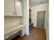 Mudroom area offers built-in desk, cabinet and storage space, with a door to the garage at 196 Grand Griffon Way, Lillington, NC 27546