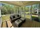 Relaxing screened porch with patio furniture and wooded views at 196 Grand Griffon Way, Lillington, NC 27546