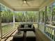 Comfortable screened porch with ceiling fan and outdoor seating overlooking wooded area at 196 Grand Griffon Way, Lillington, NC 27546