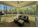 Cozy screened porch with seating area and view of the green space at 196 Grand Griffon Way, Lillington, NC 27546