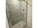 Modern shower featuring glass doors, tiled walls, and tiled floors at 196 Grand Griffon Way, Lillington, NC 27546