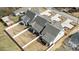 Aerial view of new construction craftsman homes featuring covered back porches with views to the community at 414 S Cross St, Youngsville, NC 27596