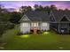Aerial of the home featuring the backyard, covered porch and lush lawn at dusk at 414 S Cross St, Youngsville, NC 27596