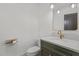 Modern powder room features stylish lighting, gold fixtures, and a dark green vanity with marble countertop at 414 S Cross St, Youngsville, NC 27596