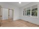 Bright, spacious bedroom with large windows and hardwood floors at 414 S Cross St, Youngsville, NC 27596