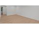 Bright bedroom with wood floor and ample natural light from exterior windows at 414 S Cross St, Youngsville, NC 27596