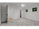 Well-lit bedroom with neutral carpet, a ceiling fan, and a view of other rooms at 414 S Cross St, Youngsville, NC 27596