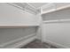 Walk-in closet featuring shelving, racks, and neutral-toned carpeted floor at 414 S Cross St, Youngsville, NC 27596