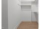 Walk-in closet with hardwood floors, and white shelving at 414 S Cross St, Youngsville, NC 27596