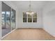Bright dining room features a modern chandelier and sliding door to a screened-in porch at 414 S Cross St, Youngsville, NC 27596