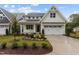 Charming two-story home with white siding, a well-manicured lawn and a two car garage at 414 S Cross St, Youngsville, NC 27596