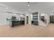 An open-concept kitchen featuring stainless steel appliances, island and hardwood floors at 414 S Cross St, Youngsville, NC 27596