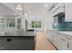 Bright kitchen with an island, a stylish backsplash, stainless steel appliances and hardwood floors at 414 S Cross St, Youngsville, NC 27596