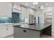 Stylish kitchen with a large island, white cabinetry, and a striking backsplash at 414 S Cross St, Youngsville, NC 27596