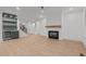 Open-concept living room with a fireplace, built-in bar area, and staircase at 414 S Cross St, Youngsville, NC 27596