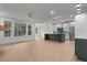 Bright, open living space featuring hardwood floors and views into the kitchen at 414 S Cross St, Youngsville, NC 27596