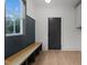 Bright mudroom with board and batten detail and storage bench seating and access to the exterior at 414 S Cross St, Youngsville, NC 27596