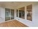 View from the covered patio showing the dining area through large glass windows at 414 S Cross St, Youngsville, NC 27596