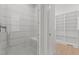 Contemporary shower with white tiles, glass door, and built in bench at 414 S Cross St, Youngsville, NC 27596