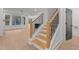 Bright home interior featuring a staircase with wooden steps and black iron railing leading to the upper level at 414 S Cross St, Youngsville, NC 27596