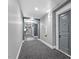 Bright hallway with modern gray walls and carpet at 222 Glenwood Ave # 307, Raleigh, NC 27603