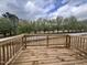 Wooden back deck overlooking a landscape with a tree-lined backdrop at 152 S Mistflower St, Clayton, NC 27520